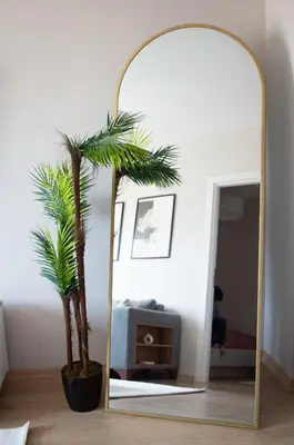 a mirror in a living room with a palm tree at Luxe Suite AI28 in Esenyurt