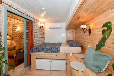 a bedroom with a bed in a wooden room at Turkish Hammam 3 BR Historical Flat 3 AC in Istanbul