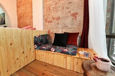 a couch sitting in a room with a brick wall at Wooden Style AC Galata in Istanbul