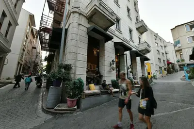 a couple of people walking down a city street at Wooden Style AC Galata in Istanbul