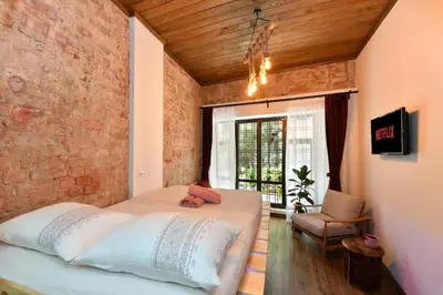 a bedroom with a bed and a brick wall at Wooden Style AC Galata in Istanbul