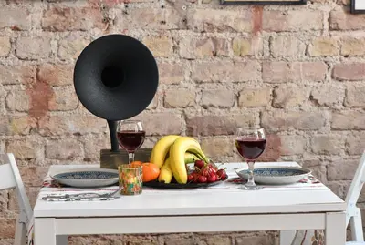 a table with a plate of fruit and two glasses of wine at Historical Wooden Style AC in Beyoğlu Galata in Istanbul