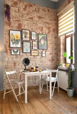 a white table and chairs in a room with a brick wall at Historical Wooden Style AC in Beyoğlu Galata in Istanbul