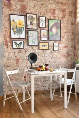 a white table and chairs in a room with a brick wall at Historical Wooden Style AC in Beyoğlu Galata in Istanbul