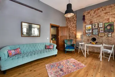 a living room with a blue couch and a brick wall at Historical Wooden Style AC in Beyoğlu Galata in Istanbul