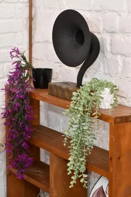 a black hat sitting on top of a wooden shelf with flowers at 2BR Unique Terrace 2 AC in Beyoğlu Galata in Istanbul