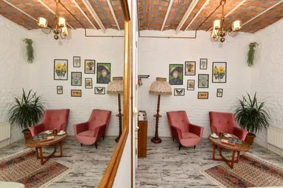 a room with red chairs and tables and pictures on the wall at 2BR Unique Terrace 2 AC in Beyoğlu Galata in Istanbul