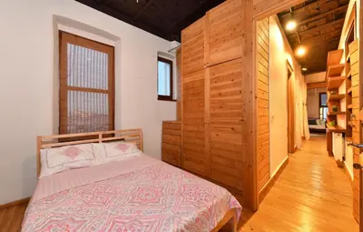 a bedroom with a bed and a wooden wall at Historical Flat Unique Terrace AC in Beyoğlu Galata in Istanbul