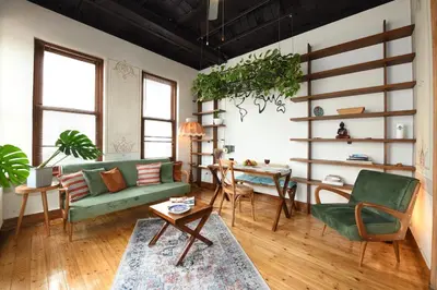 a living room with a green couch and a table at Historical Flat Unique Terrace AC in Beyoğlu Galata in Istanbul