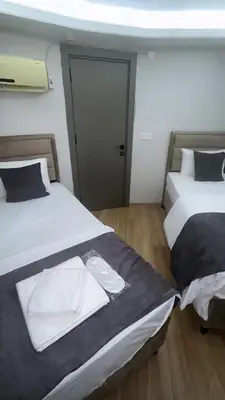 two beds sitting next to each other in a room at Mesil Hotel in Istanbul