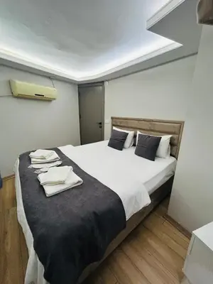 a bedroom with a large bed with towels on it at Mesil Hotel in Istanbul