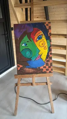 a painting of a woman on a chair at Karahan bungalov in Tayakadın