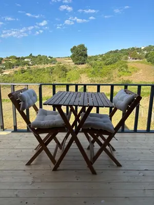 a wooden picnic table and chairs on a deck at Karahan bungalov in Tayakadın