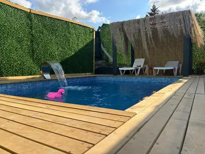 a swimming pool with a pink pig in the water at Karahan bungalov in Tayakadın