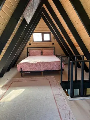 a room with a bed in a attic at Karahan bungalov in Tayakadın