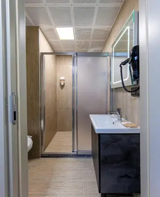 a bathroom with a shower and a sink at Çorlu Temel Hotel in Corlu