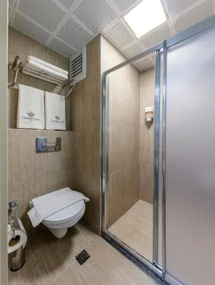 a bathroom with a shower and a toilet at Çorlu Temel Hotel in Corlu