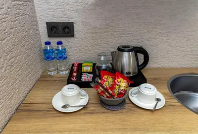 a counter with a coffee pot and cups and snacks at Çorlu Temel Hotel in Corlu