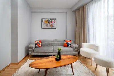 a living room with a couch and a table at Pia Homes- Gümüşsuyu in Istanbul