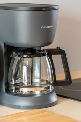 a black coffee maker sitting on top of a counter at Pia Homes- Gümüşsuyu in Istanbul