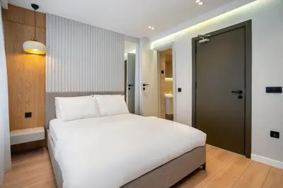 a bedroom with a large white bed and a door at Pia Global - Nevizade in Istanbul