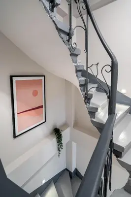 a staircase with a framed picture and a plant on the wall at Pia Global - Nevizade in Istanbul
