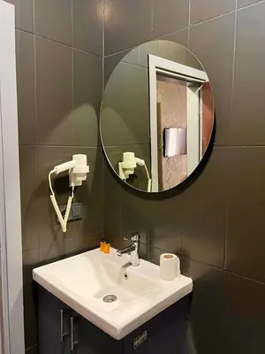 a bathroom with a sink and a mirror at GÜNEŞLİ SUİT OTEl in Istanbul