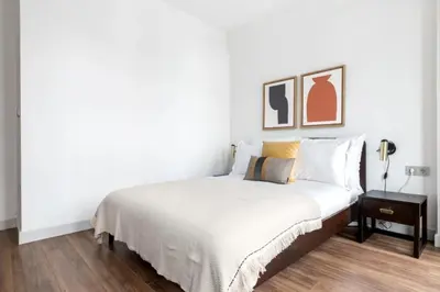 a white bedroom with a bed and a night stand at Elegant & Charming Apartment in Beyoglu in Istanbul