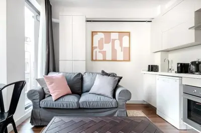 a living room with a couch and a kitchen at Elegant & Charming Apartment in Beyoglu in Istanbul