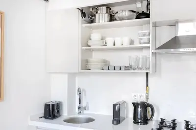 a kitchen with a sink and a cupboard with dishes at Elegant & Charming Apartment in Beyoglu in Istanbul