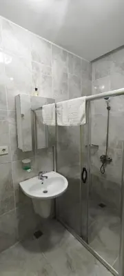a bathroom with a sink and a shower at Şişli Suites - Room22 in Istanbul