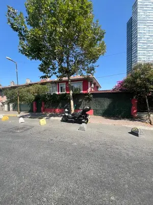 a motorcycle parked in a parking lot next to a house at Şişli Suites - Room22 in Istanbul