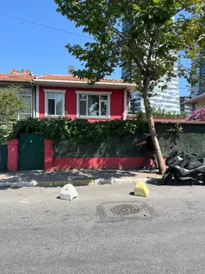 a red house with a motorcycle parked in front of it at Şişli Suites - Room22 in Istanbul