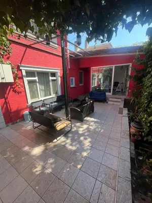 a patio with couches and a red building at Şişli Suites - Room22 in Istanbul