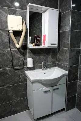 a bathroom with a white sink and a mirror at Emir City Hotel in Bursa