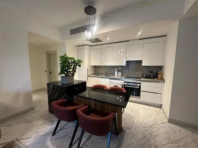 a kitchen with a table and some red chairs at Luxury family-balcony apt in Istanbul