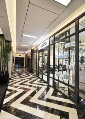 a hallway of a shopping mall with a checkered floor at Luxury family-balcony apt in Istanbul