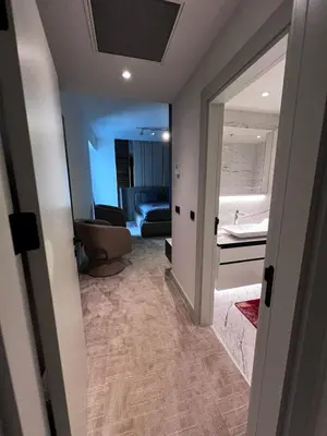a hallway with a room with a bed and a mirror at Luxury family-balcony apt in Istanbul