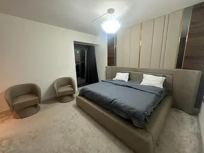 a bedroom with a bed and a chair in it at Luxury family-balcony apt in Istanbul