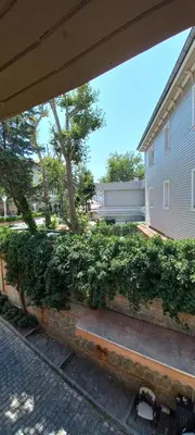 a green hedge in front of a building at Coskun apt in Istanbul