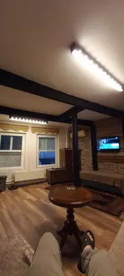 a person laying on a couch in a living room with a table at Coskun apt in Istanbul