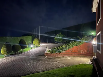a street at night with lights on a fence at Luxury Mansion Amazing View, Hidden Garden in Celâliye