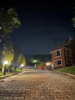 a cobblestone street at night with a house at Luxury Mansion Amazing View, Hidden Garden in Celâliye