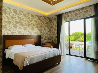 a bedroom with a bed and a view of a patio at My Green Otel in Sapanca