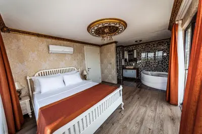 a bedroom with a bed and a bath tub at My Green Otel in Sapanca
