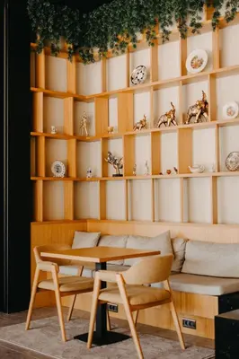 a table and two chairs in a room with shelves at Melekona House in Kartepe