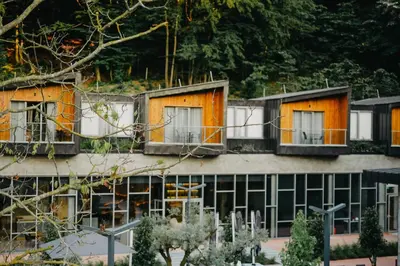 a building with orange doors and windows on it at Melekona House in Kartepe