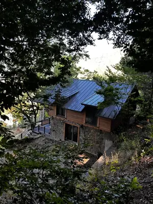 a house with a metal roof on top of it at Çalıkuşu Dağ Evi in Bursa