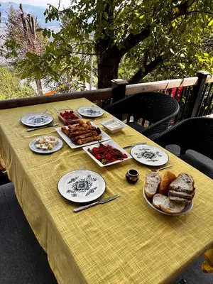a yellow table with plates of food on it at Çalıkuşu Dağ Evi in Bursa