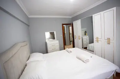 a bedroom with a white bed with two towels on it at Nomadia turkey in Istanbul